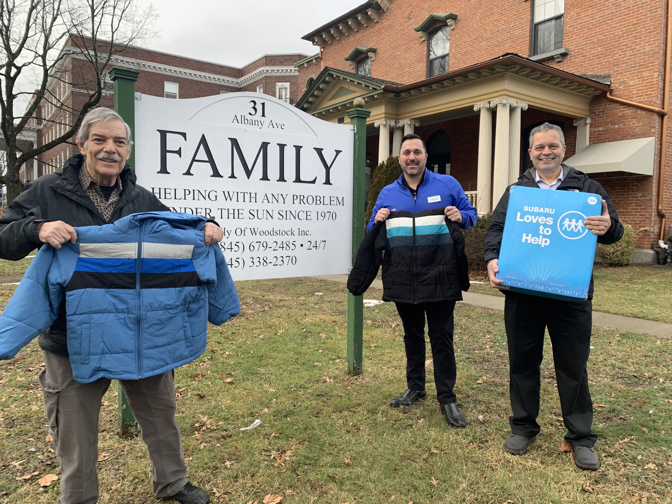 Family of Woodstock and Curry Subaru Distribute Coats to Children